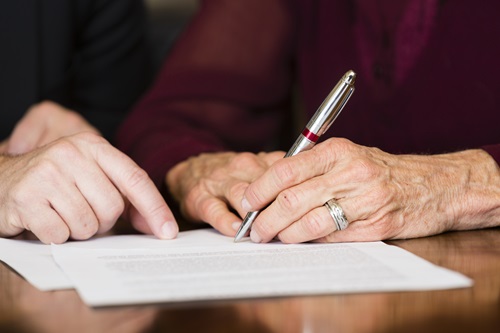 Woman signing documents 